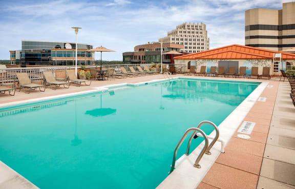The Metropolitan in Bethesda, MD features a gorgeous rooftop pool with sundeck, lounge chairs, and city views.