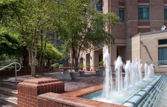 Peaceful courtyard fountain with seating areas at The Metropolitan, Bethesda 20814