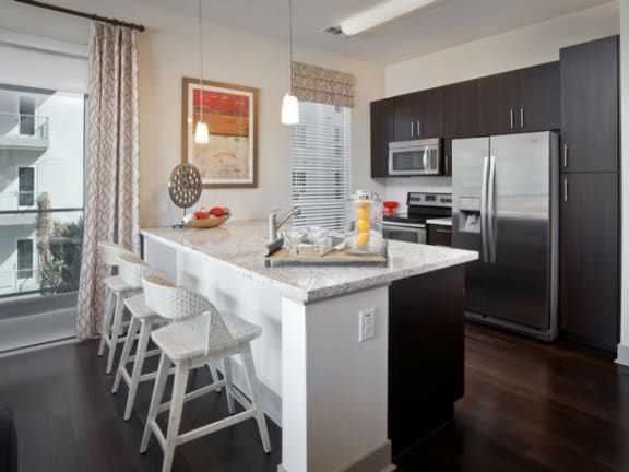 Gourmet Kitchens with Islands, Caesarstone Countertops, and Decorative Backsplash at South Park by Windsor, Los Angeles, CA 90015
