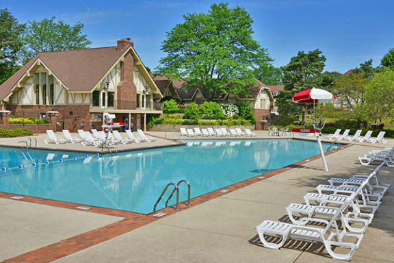 Outdoor Swimming Pool and Lounge Chairs at The Village Apartments, Wixom 48393