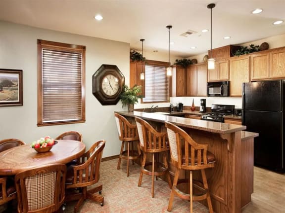 a kitchen with a large clock on the wall