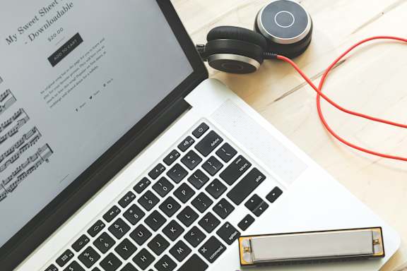 laptop_on_desk_with_headphones at Sumida Gardens Apartments, Santa Barbara, CA