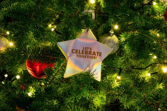 a christmas tree with a star that says let's celebrate together
