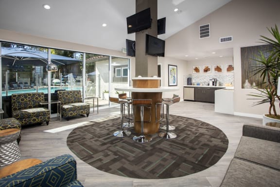 a living room with a table and chairs in front of a pool at Pointe Niguel, Laguna Niguel, California