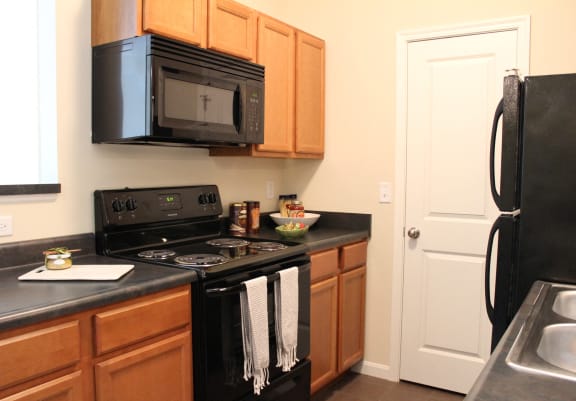 Kitchen with black appliances at Residences at Northgate Crossing, Ohio, 43235