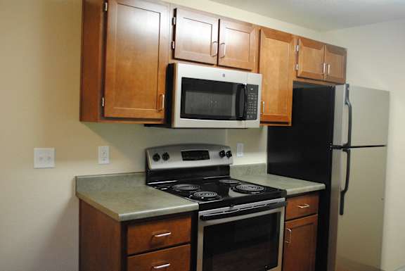 Wooden cabinets and appliances at Commons at Creekside Apartments, Hillsboro, OR