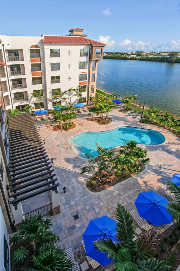 An aerial view of the Crystal Riviyera's pool, sun deck, and lakeside barbecue area.
