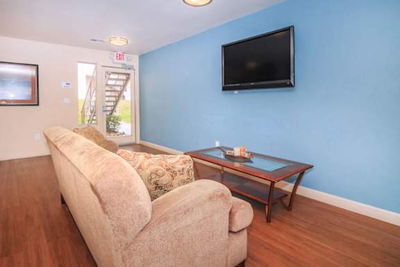 a living room with a couch and a table and a television at Desert Bay Apartments, Laughlin, NV, 89029