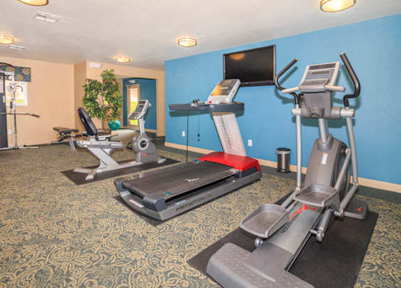 a gym with exercise machines and a television at Desert Bay Apartments, Laughlin, Nevada