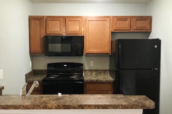 Kitchen With White Cabinetry And Black Appliances at Eagle Crest Apartments, Ohio