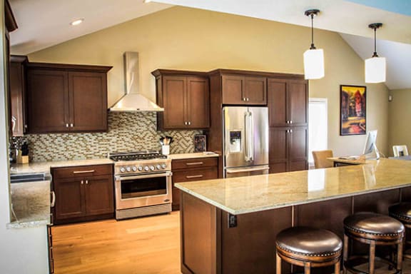 Fully equipped kitchen with brown accents and granite counter tops