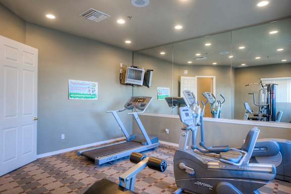 A gym with treadmills at San Miguel Apartments, Arizona 85212