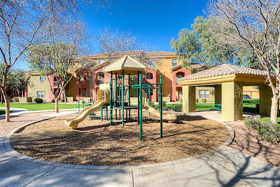 A playground with a yellow slide at San Miguel Apartments, Mesa, 85212
