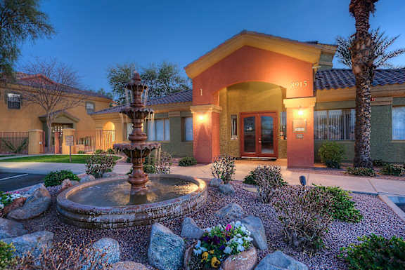 A house with a fountain in front of it at San Miguel Apartments, Mesa, AZ