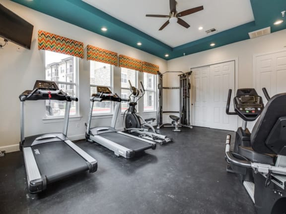 Fitness center with refreshing pool viewsat CLEAR Property Management , The Lookout at Comanche Hill, San Antonio, Texas