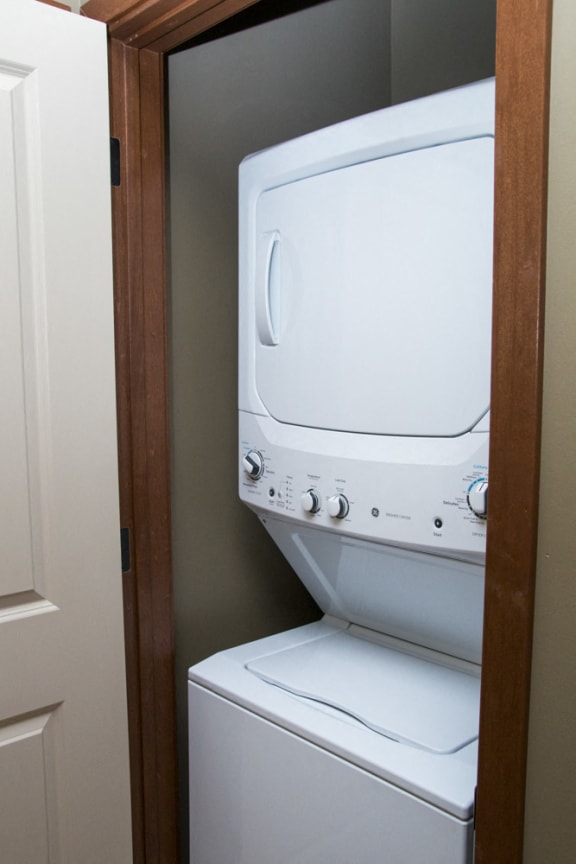 Stacked washer and dryer combo stored in closet at The Villas of Omaha at Butler Ridge in Omaha, NE