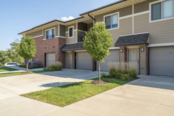 A row of houses with garages and driveways.