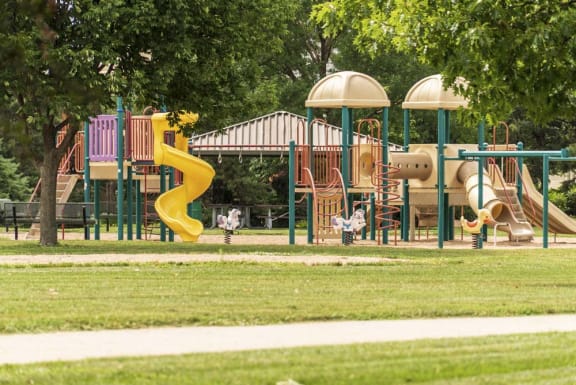 Playground at williamsburg park with slides and swings Williamsburg Park Apartments in South Lincoln, Nebraska