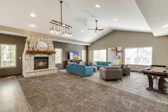 A spacious living room with a fireplace and a television.