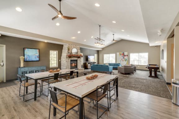 A modern dining room with a large table and chairs.