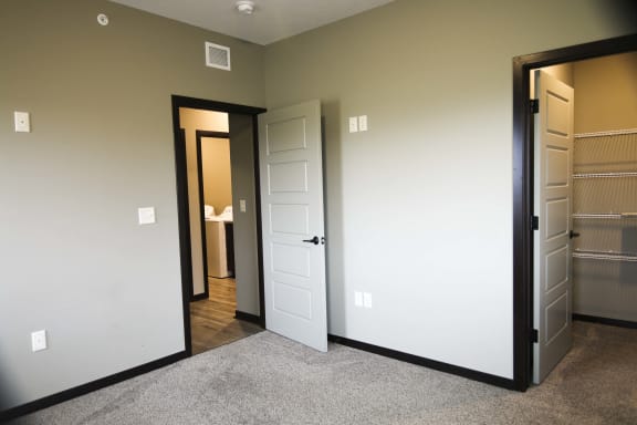 Bedroom with attached walk in closet at North Pointe Villas