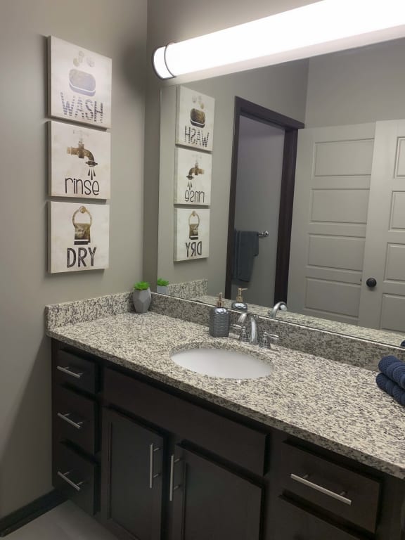 Large vanity with granite counter tops in the full bath in the Harper three bedroom floor plan