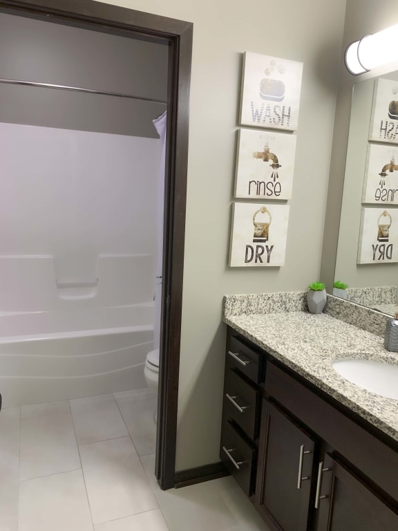 Large vanity, private toilet and tub shower area in the full bathroom of the Harper floor plan at North Pointe Villas in Lincoln NE