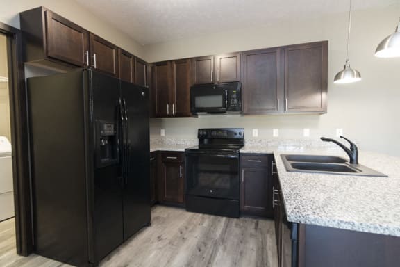 Kitchen with lots of granite counter space and matching all black appliances Comfortable couch seating in the clubhouse at North Pointe Villas in north Lincoln, Nebraska
