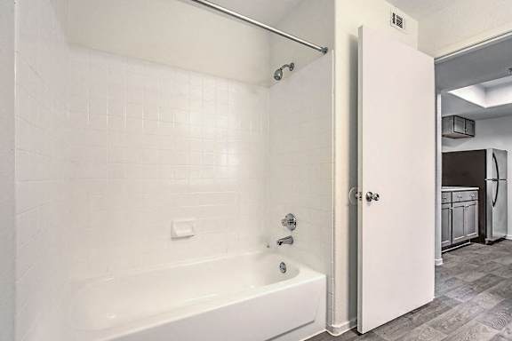 Large Soaking Tub In Master Bathroom With A Tile Surround at The 95 Apartments, Las Vegas, NV, 89129