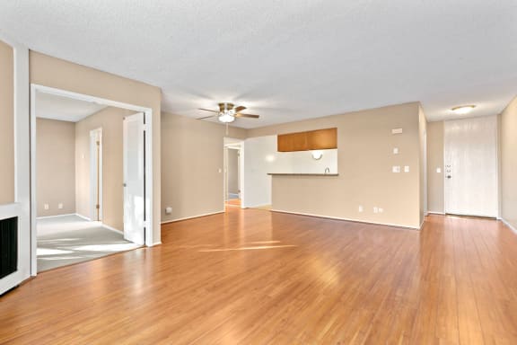 a living room with hardwood floors and a ceiling fan