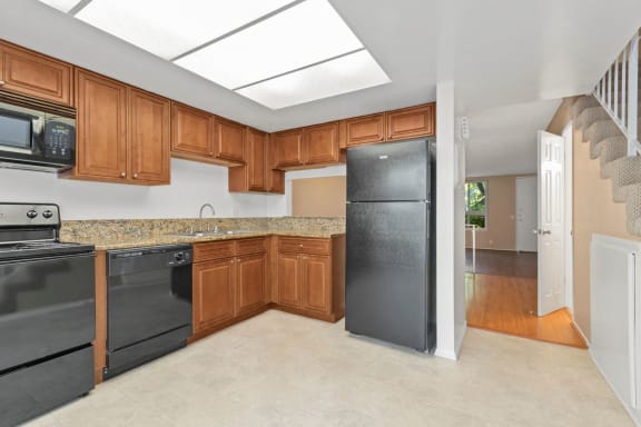 a kitchen with wooden cabinets and black appliances