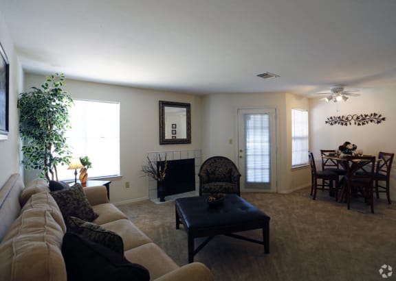 A living room with a couch, chair, and fireplace at The Trails at Mt. Moriah, Memphis, Tennessee