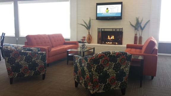 Clubhouse with couches and fireplace at Dover Hills Apartments, Kalamazoo, MI