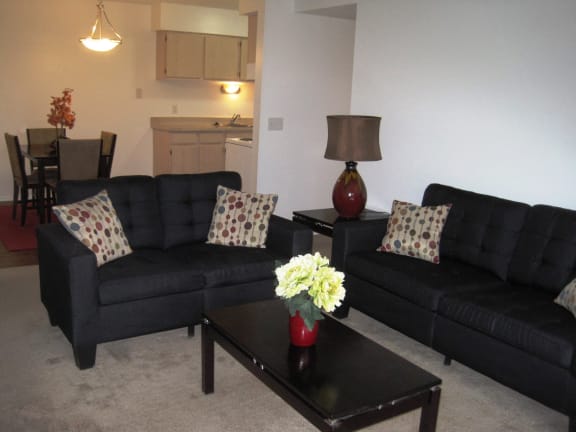 Living Room with couches in short-term furnished apartments available at Dover Hills Apartments in Kalamazoo, Michigan