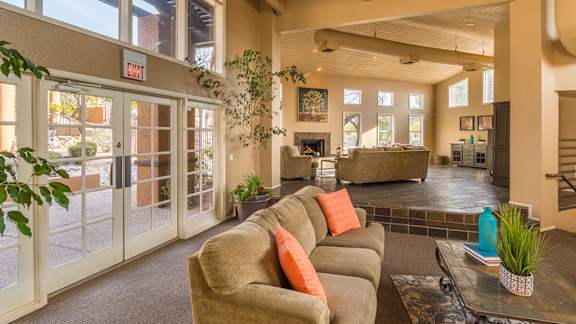 Arboretum view of clubhouse with a couch and lovely glass doors and windows