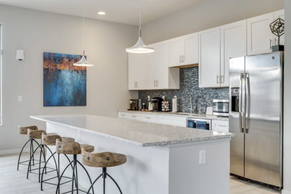 A kitchen with a bar area and stools.
