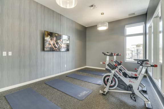 A room with a grey wall and a picture hanging on it.