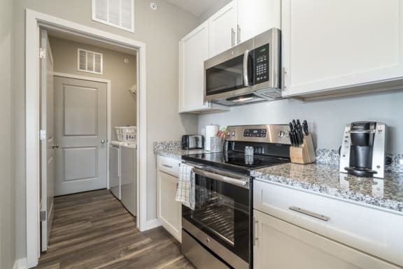 A kitchen with a stove top oven and microwave.