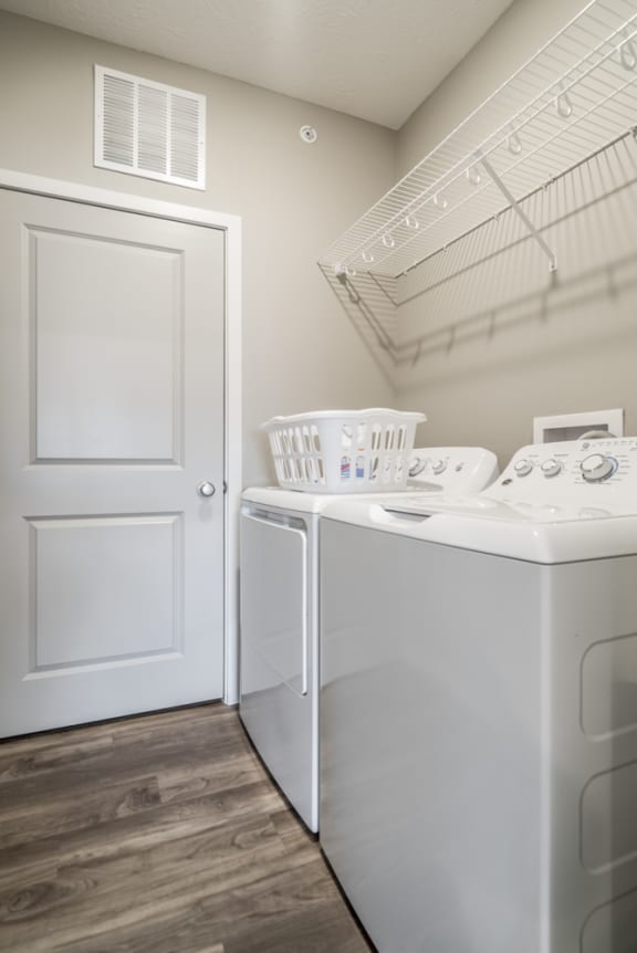 A white door is next to a white washing machine.