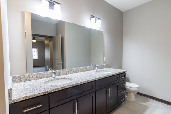 Dual sink counter top in the bathroom at 360 at Jordan West