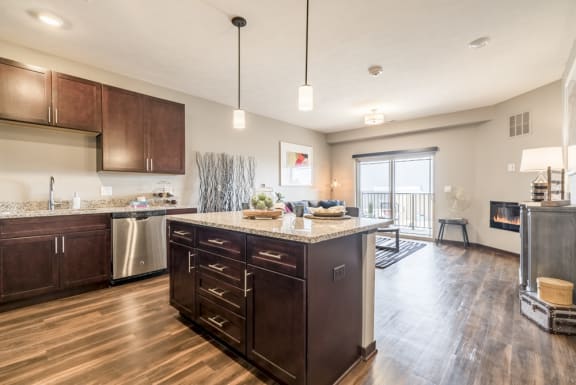 Kitchen island providing extra cabinet space and pendant lighting at 360 at Jordan West
