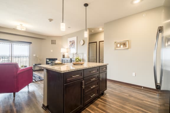View of kitchen island and living room at 360 at Jordan West