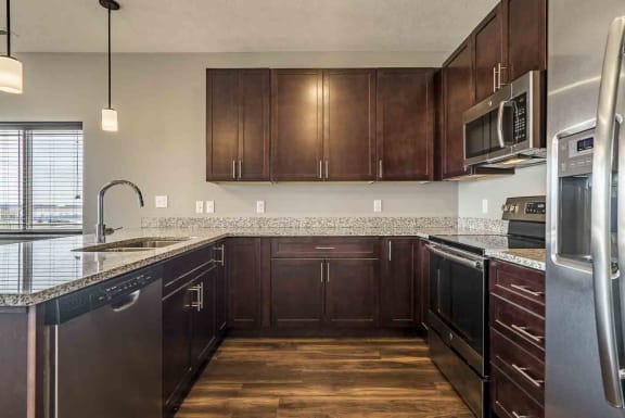 Kitchen space with updated stainless steel appliances and granite counter tops at 360 at Jordan West