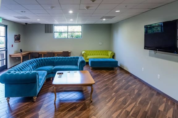 Lounge with sofas and TV at The Verandas, Canoga Park, CA