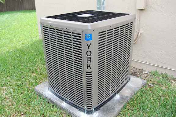 a heat pump on the grass