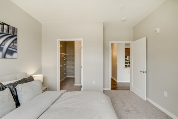 Spacious furnished bedroom with walk-in closet at Ascend at Woodbury in Woodbury, MN