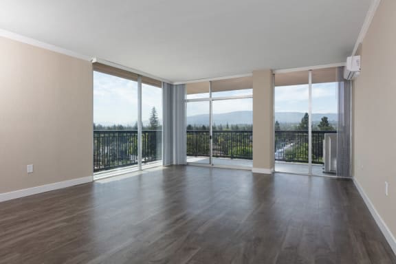an empty living room with sliding glass doors and a balcony