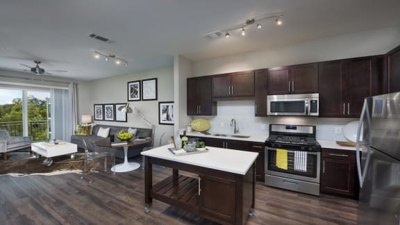 Kitchens Complete with Custom Espresso Cabinetry and Hard Surface Quartz Counters at Morningside Atlanta by Windsor, Atlanta, GA