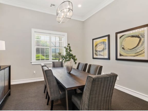 Gorgeous Dining Room Space with Elegant Lighting and Wood Plank Flooring at Cambridge Square Apartments, Overland Park, KS 66211
