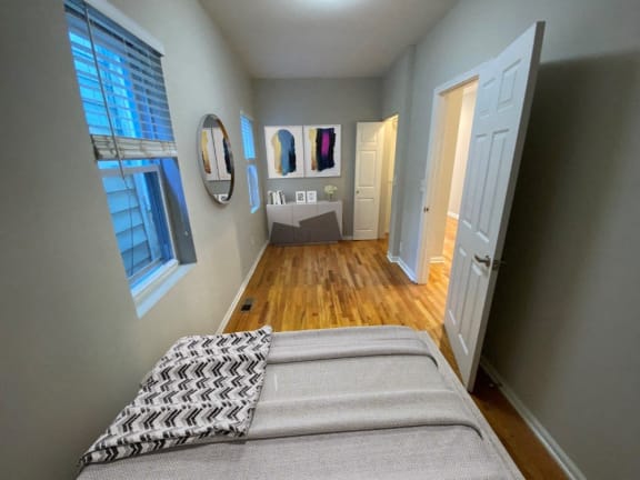 Virtually furnished bedroom with hardwood floors